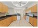 Open kitchen with natural wooden cabinets, tile flooring, granite countertops and modern appliances at 12805 Coronado Dr, Spring Hill, FL 34609