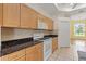 Traditional kitchen showcasing wood cabinets, granite countertops, and stainless steel appliances at 12805 Coronado Dr, Spring Hill, FL 34609