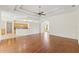 Open living room with hardwood floors adjacent to the kitchen and dining area with coffered ceilings at 12805 Coronado Dr, Spring Hill, FL 34609