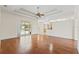 Living room with sliding glass doors leading to pool area, hardwood floors, and tray ceiling at 12805 Coronado Dr, Spring Hill, FL 34609