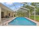 Inviting in-ground pool with screened enclosure and ample patio space for relaxing and entertaining outdoors at 12805 Coronado Dr, Spring Hill, FL 34609