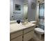 Bathroom featuring a vanity with a sink, toilet, shower, and nautical-themed decorations at 13316 Brigham Ln, Hudson, FL 34667