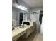 Bathroom with a vanity, single sink, and a mirror; tile flooring and a doorway to another room at 13316 Brigham Ln, Hudson, FL 34667