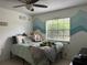 Bedroom with a bed, ceiling fan, window, and playful aquatic-themed decor, perfect for a  at 13316 Brigham Ln, Hudson, FL 34667