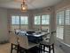 Bright dining room with white shutters, pendant lighting, and seating for six at 13316 Brigham Ln, Hudson, FL 34667