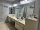 Bathroom featuring double sinks, large mirror, ample counter space, and modern fixtures at 13316 Brigham Ln, Hudson, FL 34667