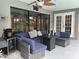 Outdoor patio with comfortable seating, ceiling fan, and views of the backyard at 13316 Brigham Ln, Hudson, FL 34667