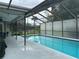 Screened-in pool with covered patio, plenty of space for lounging, and lush landscaping at 13316 Brigham Ln, Hudson, FL 34667