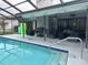 Enjoy outdoor living with a poolside patio, complete with comfortable seating and a barbecue area at 13316 Brigham Ln, Hudson, FL 34667