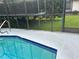 A beautiful pool with blue tile trim provides the perfect spot to relax and enjoy the outdoors at 13316 Brigham Ln, Hudson, FL 34667