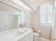 Bathroom with a vanity, large mirror, toilet, and shower-tub combination at 13922 Talmage Loop, Hudson, FL 34667