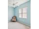 Bright bedroom featuring a ceiling fan and a comfortable armchair at 13922 Talmage Loop, Hudson, FL 34667