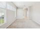 Spacious bedroom with neutral carpet and white shutters, featuring a view of the en-suite bathroom and closet at 13922 Talmage Loop, Hudson, FL 34667