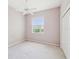 Cozy bedroom with neutral carpet, ceiling fan, window, and a closet with sliding doors at 13922 Talmage Loop, Hudson, FL 34667