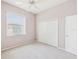 Bedroom with carpet, ceiling fan, window providing natural light, and a closet with sliding doors at 13922 Talmage Loop, Hudson, FL 34667