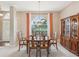 Formal dining room with a wooden table, chairs, chandelier, and large window at 13922 Talmage Loop, Hudson, FL 34667