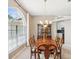 Spacious dining area with wooden table set and natural light from a large window at 13922 Talmage Loop, Hudson, FL 34667