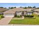 Well-maintained single-story home with manicured lawn and brick-paved driveway, situated in a desirable neighborhood at 13922 Talmage Loop, Hudson, FL 34667