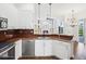 Bright kitchen with white cabinets, stainless dishwasher, and open view to living room at 13922 Talmage Loop, Hudson, FL 34667