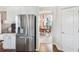 Modern kitchen featuring stainless steel appliances, white cabinets, and a view to the adjacent dining room at 13922 Talmage Loop, Hudson, FL 34667