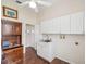 Functional laundry room with ample cabinet storage and a sink at 13922 Talmage Loop, Hudson, FL 34667