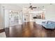 Spacious living room with hardwood floors, chandelier, couch, and open access to the kitchen and screened patio at 13922 Talmage Loop, Hudson, FL 34667