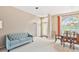 Inviting living room showcasing a blue sofa, dining table, and open layout at 13922 Talmage Loop, Hudson, FL 34667