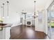 Bright living room with hardwood floors, fireplace, built-in shelves, chandelier and sliding glass doors to the patio at 13922 Talmage Loop, Hudson, FL 34667