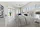 Bright main bedroom featuring a vaulted ceiling, ample natural light, and elegant neutral decor at 13922 Talmage Loop, Hudson, FL 34667