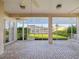 Spacious screened-in patio with brick flooring and swing at 13922 Talmage Loop, Hudson, FL 34667