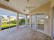 Relaxing screened-in patio with brick flooring and a swing at 13922 Talmage Loop, Hudson, FL 34667