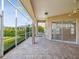 Comfortable screened-in patio with brick flooring and a swing at 13922 Talmage Loop, Hudson, FL 34667