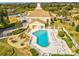 Aerial view of a community pool, lounging area, and meticulously landscaped grounds at 13922 Talmage Loop, Hudson, FL 34667