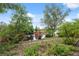 Backyard landscaping with a view of the water feature and lush foliage at 1471 N Jasmine Ave, Tarpon Springs, FL 34689