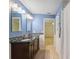 Cozy bathroom with a stylish vanity, double sinks, and tile flooring at 1471 N Jasmine Ave, Tarpon Springs, FL 34689