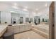 Elegant bathroom with double sinks, a soaking tub, and marble tile at 1471 N Jasmine Ave, Tarpon Springs, FL 34689
