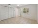 Bright bedroom with tile flooring, plantation shutters and a spacious closet at 1471 N Jasmine Ave, Tarpon Springs, FL 34689