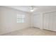Bright bedroom features tiled floors, natural light, and ample closet space at 1471 N Jasmine Ave, Tarpon Springs, FL 34689