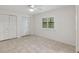 Inviting bedroom features tile floors, plantation shutters, and closet space at 1471 N Jasmine Ave, Tarpon Springs, FL 34689