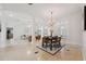 Open-concept dining area featuring marble floors, decorative chandelier, and easy access to living spaces at 1471 N Jasmine Ave, Tarpon Springs, FL 34689