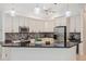 Bright kitchen with stainless steel appliances, granite counters, and stylish backsplash at 1471 N Jasmine Ave, Tarpon Springs, FL 34689