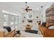 Spacious living room with fireplace, high ceilings, and access to the pool area at 1471 N Jasmine Ave, Tarpon Springs, FL 34689
