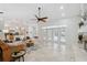 Open-concept living area with a modern fireplace and seamless flow to kitchen and outdoor spaces at 1471 N Jasmine Ave, Tarpon Springs, FL 34689