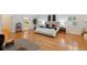 Large bedroom with wood floors, plantation shutters, and a view into the Primary bath at 1471 N Jasmine Ave, Tarpon Springs, FL 34689