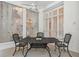 Covered outdoor patio area with an ornate metal table set and fan overhead at 1471 N Jasmine Ave, Tarpon Springs, FL 34689