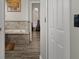 Bathroom featuring a soaking tub, tiled walls, and view into a living room at 1862 Wood Bend St, Tarpon Springs, FL 34689