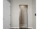 Bathroom features a glass door shower with tiled walls, flooring, and ceiling at 1862 Wood Bend St, Tarpon Springs, FL 34689