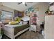 Well-lit bedroom with posters, plush green bedding, and a ceiling fan, creating a warm space for any decor at 1862 Wood Bend St, Tarpon Springs, FL 34689