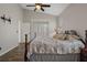 Spacious bedroom features a ceiling fan, sliding doors, and dark wood floors at 1862 Wood Bend St, Tarpon Springs, FL 34689