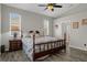 Bright bedroom features a ceiling fan, wood floors, and large windows for plenty of light at 1862 Wood Bend St, Tarpon Springs, FL 34689
